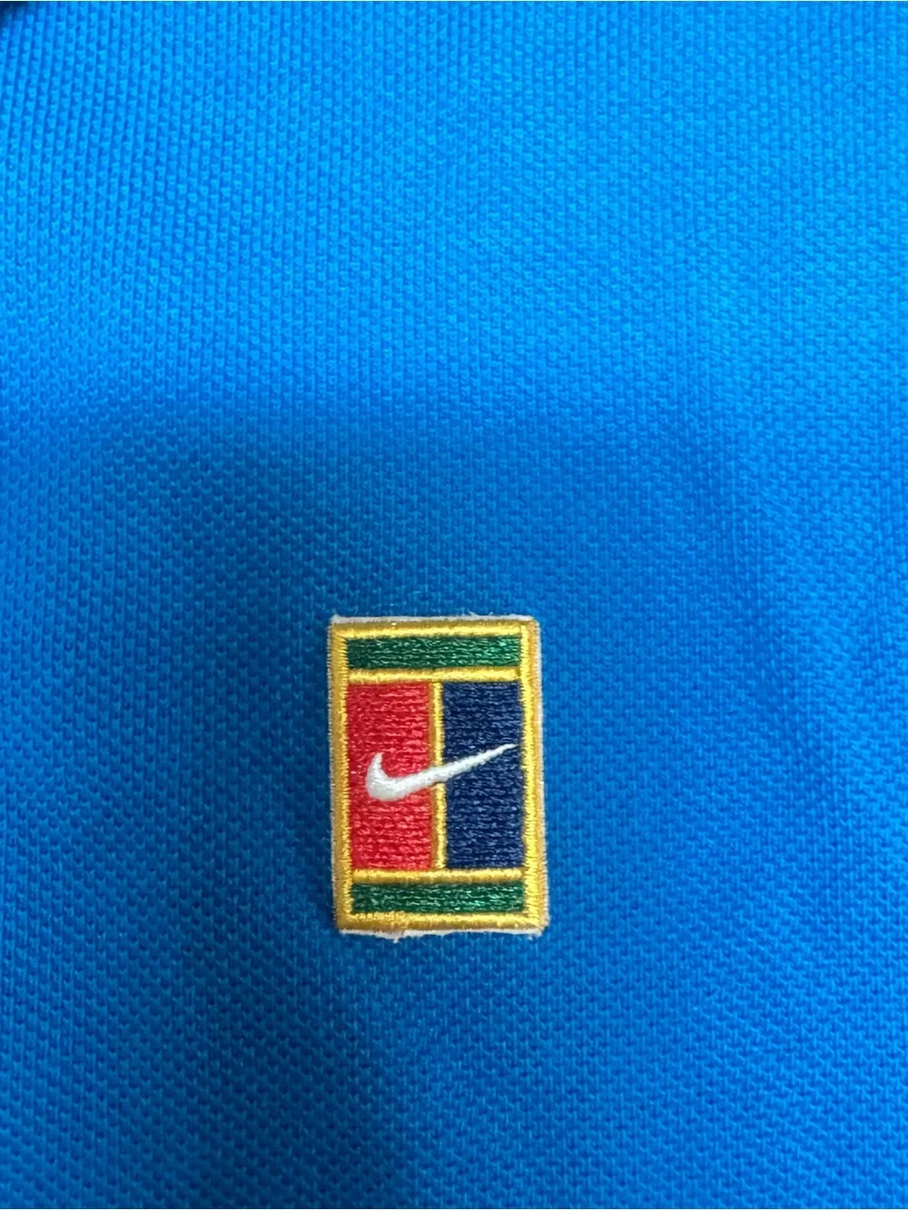 Nike Court Heritage Tennis Blue Polo Shirt with Small Multicolor Crest L